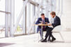 stock-photo-73550601-two-business-colleagues-at-meeting-in-modern-office-interior