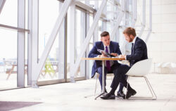 stock-photo-73550601-two-business-colleagues-at-meeting-in-modern-office-interior