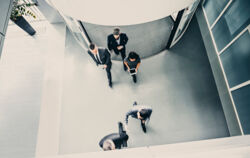 stock-photo-82070417-group-of-businesspeople-entering-the-lobby